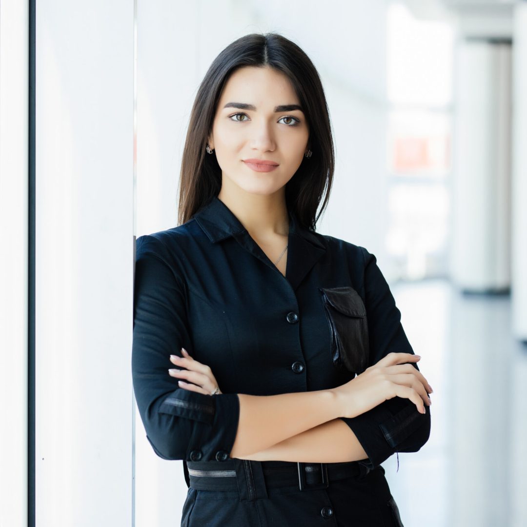 Businesswoman crossed hands in office with panormic windows.