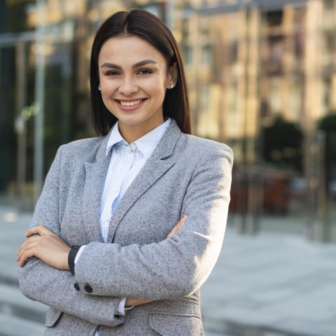 smiley-businesswoman-posing-outdoors-with-arms-crossed-copy-space